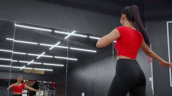 美丽的年轻亚洲女子在健身馆健身俱乐部的镜子前跳芭蕾舞锻炼有氧运动女性训练运动和热身优雅的努力饮食健康和护理