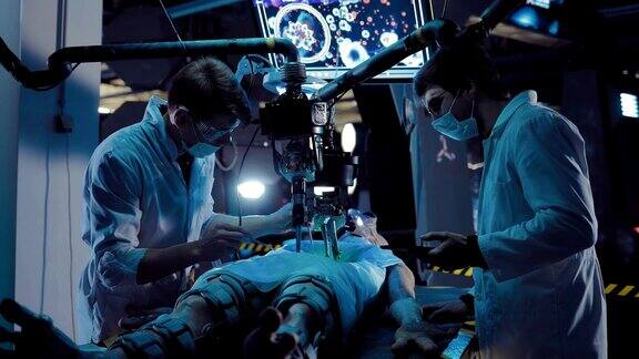 年轻的外科医生在外星人身上进行科学实验实验室助手在设备和工具的帮助下对一个外星人进行尸检