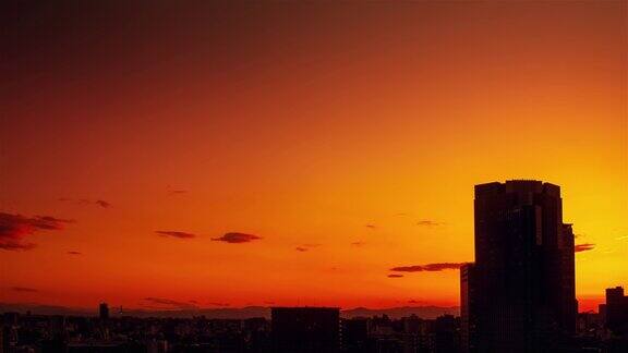 视频的天空云城市和建筑物夜景从日落