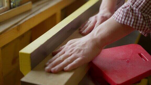 男木工在木工刨床上加工橡木板的手