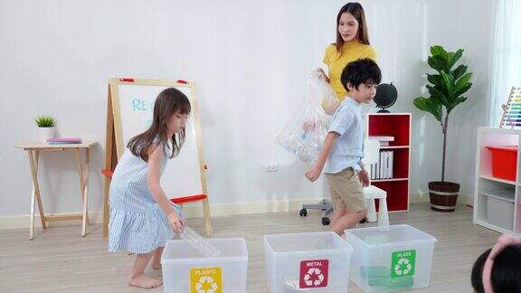 在小学的课堂上亚洲老师正在检查他们的孩子们对垃圾分类的理解如玻璃金属和塑料
