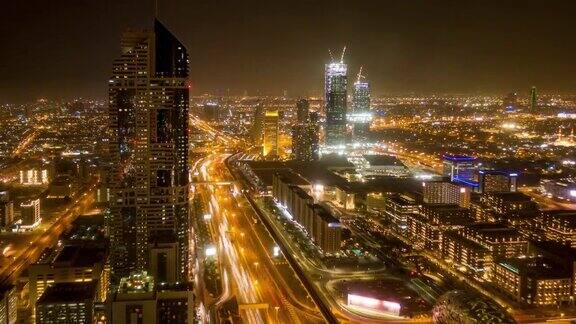 阿联酋迪拜高速公路枢纽的鸟瞰图日落时交通时间流逝迪拜市中心著名的谢赫·扎耶德路从屋顶观看交通和驾驶概念