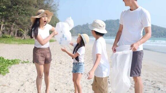 4k慢镜头亚洲之家志愿者在有海的海滩捡起一个塑料瓶保护环境
