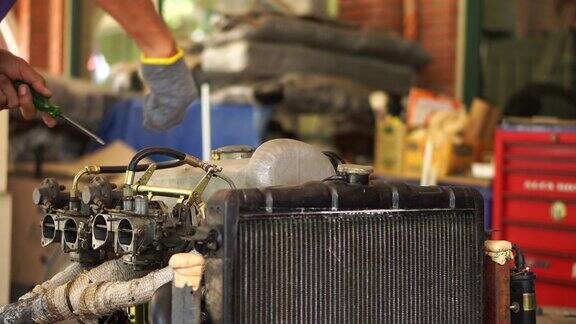 男子在车库里修理奔驰190sl发动机