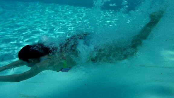 女孩在游泳池里跳跃水下慢动作