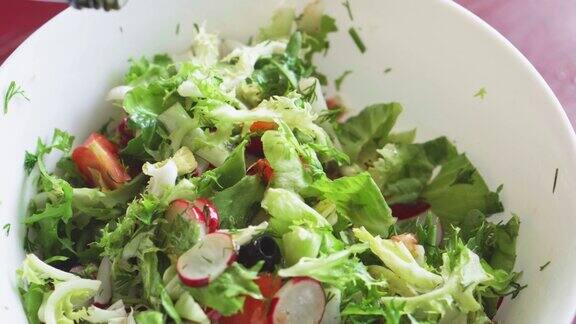 新鲜蔬菜沙拉在厨房里做健康的食物素食主义者的饮食健康午餐的特写有萝卜西红柿生菜芳香的绿色蔬菜和橄榄女人切拌沙拉