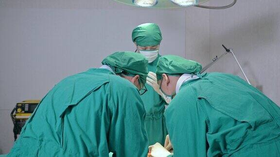 在医院的手术室里外科医生们穿着手术服给一名严重受伤的病人做手术