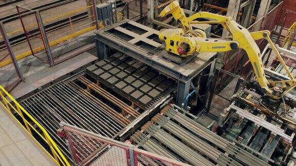 现代机械臂正准备运输砖块现代化的自动化工厂设备