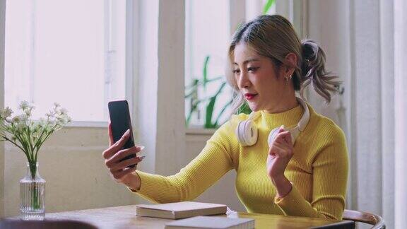 亚洲女性在智能手机上使用视频通话会议