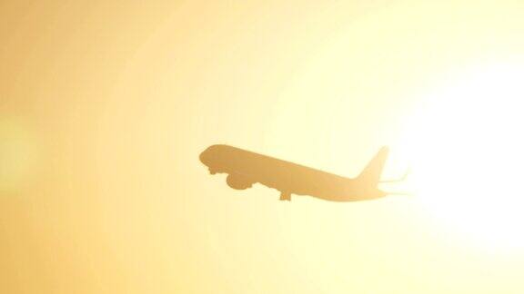 飞机在傍晚的天空中迎着太阳耀斑飞行