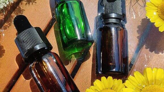 棕色和绿色的瓶子里装着鲜花里的精油天然护肤化妆品注重健康和美丽