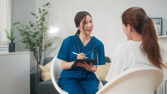快乐的女医生在家访时检查并与年轻女性交谈保健医生在检查预约时与健康患者交谈