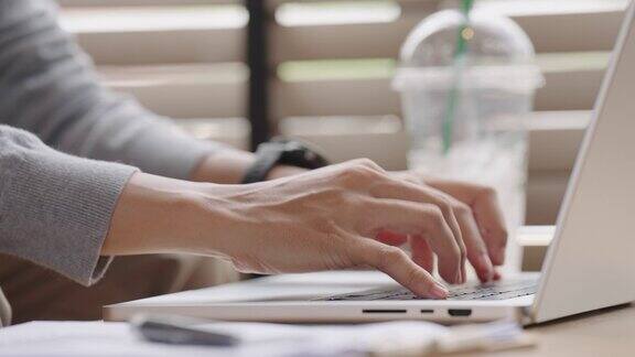 商务女性用手和手指敲击键盘的近照桌上的笔记本电脑网络营销自由职业者在家工作