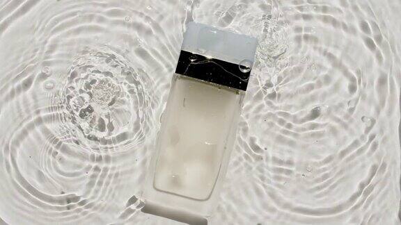 化妆品面霜一瓶乳液精华液胶束化妆水和乳液在水的背景与飞溅美容spa医学护肤品化妆品的广告
