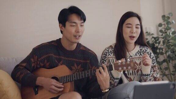 亚洲朋友在网上通过视频通话一起演奏音乐
