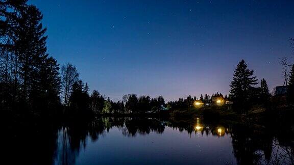 银河和星星的时间流逝在一个平静的湖泊和树木的剪影