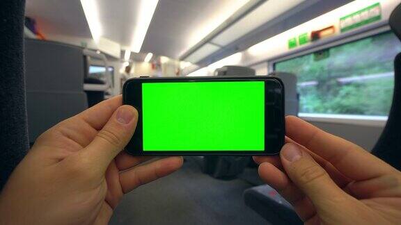 在火车上用手拿着绿屏手机