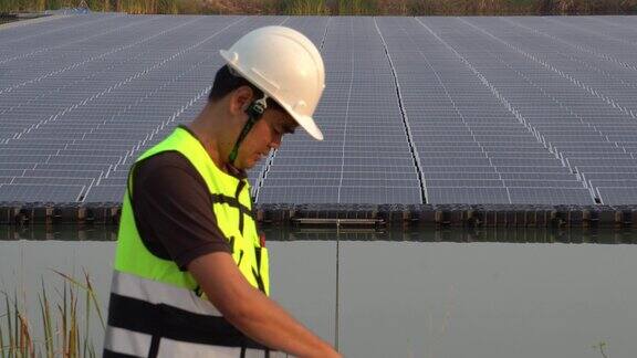 4K镜头:中东阿拉伯人与工程师一起检查太阳能农场