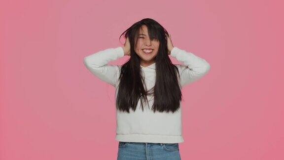 美丽的亚洲年轻女孩长强壮健康的头发摇弄乱的头发护发美容化妆品广告