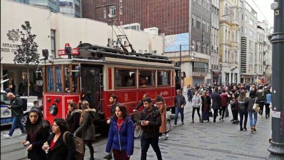 伊斯坦布尔市伊斯提卡尔大街上的有轨电车人群在行走