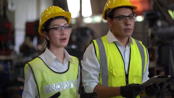 亚洲工业工程师经理男用平板电脑与机械工人女操作工业检验和检查质量控制