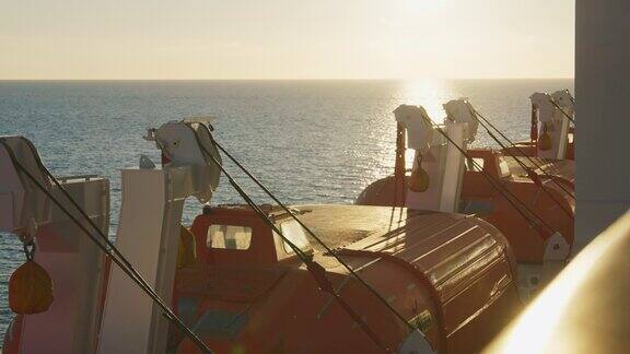 大型客船上的救援船邮轮上的救生艇以落日为背景的美丽大海