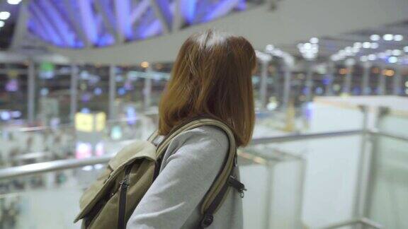 年轻的亚洲女背包客在国际机场散步