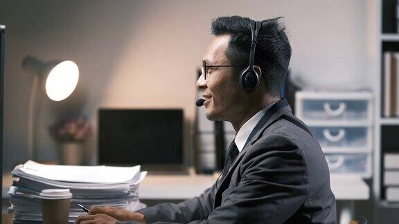 呼叫中心打字和商务人员在办公室的电脑上为客户服务电话营销微笑和男性个人电脑销售代理或顾问工作的支持咨询和帮助在线