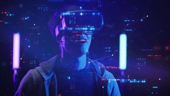十几岁的孩子玩虚拟现实眼镜运动游戏未来霓虹五彩背景未来科技游戏和娱乐