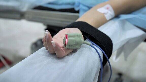 病人手指上的脉搏血氧计手术期间安装在患者手上的外周静脉导管(PVC)慢动作