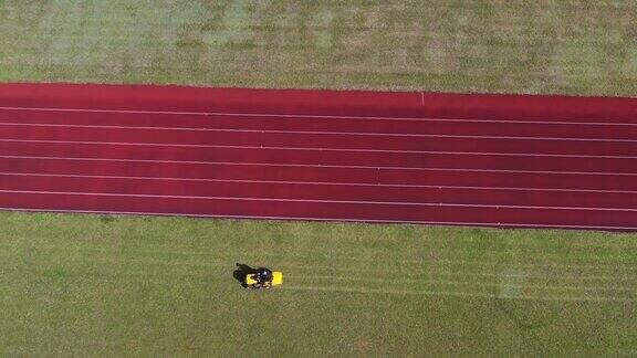 草坪割草机割着体育场的绿草aeria