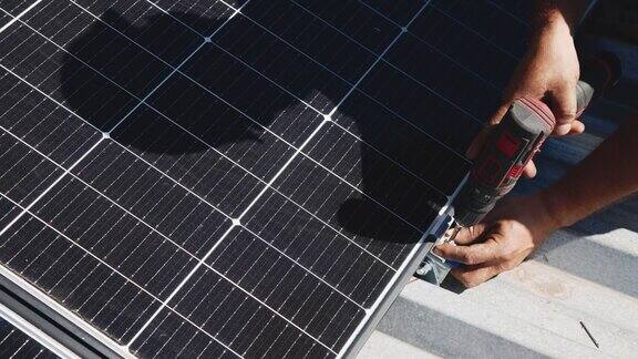 工人在金属支架上安装太阳能电池板(特写)房屋屋顶人工安装光伏太阳能板的近景工程师在户外工作