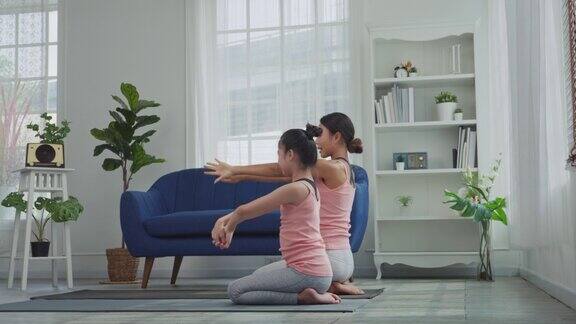 母女俩正在家里练习瑜伽