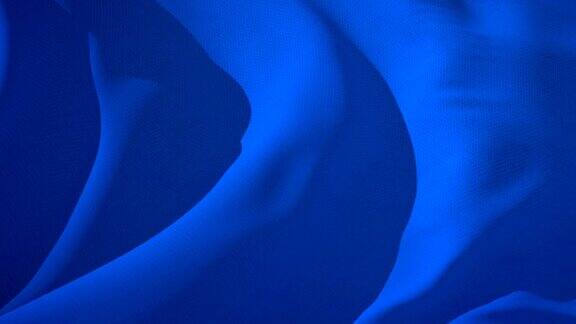 深蓝色的纺织织物在风中飘扬抽象的背景