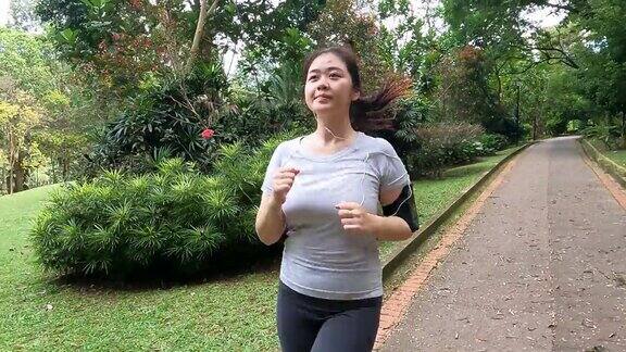 周末早上在公园里跑步的亚洲华裔年轻女性
