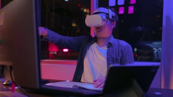 虚拟世界会议技术富有创意的亚洲成年男性工程师编程晚上戴着vr头戴设备在家庭工作室使用虚拟增强现实3d模型