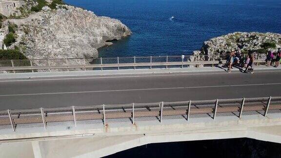 航拍无人机飞出海湾越过一座桥飞向大海