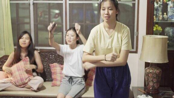 亚洲母女在电视机前做家庭运动被新冠病毒封锁