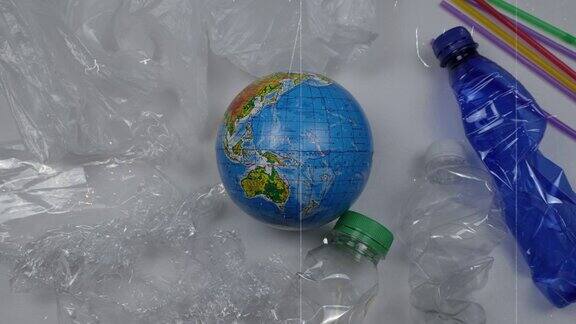 停止塑料污染地球被塑料垃圾包围着塑料瓶鸡尾酒管包装纸袋子世界环境日时间流逝用乌克兰西里尔语命名的地球