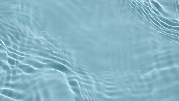 水面纹理俯视图水溅起蓝色纯净的蓝色海水以慢动作反射阳光阳光和阴影运动清洁游泳池的涟漪和波浪4k
