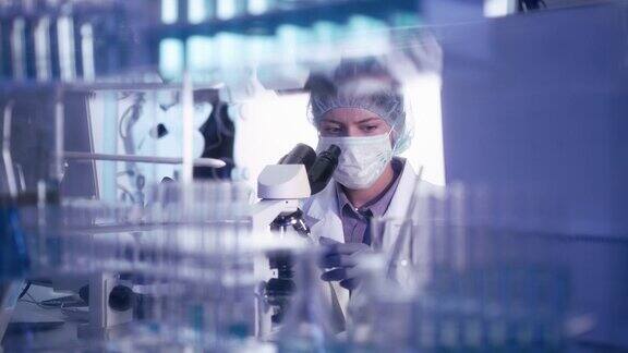年轻的实验室工作人员穿着防护服研究冠状病毒