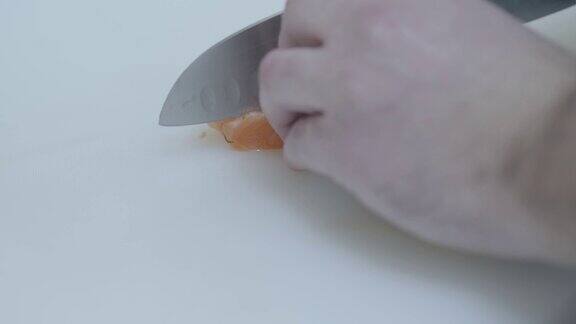 厨师用大刀将三文鱼切成薄片
