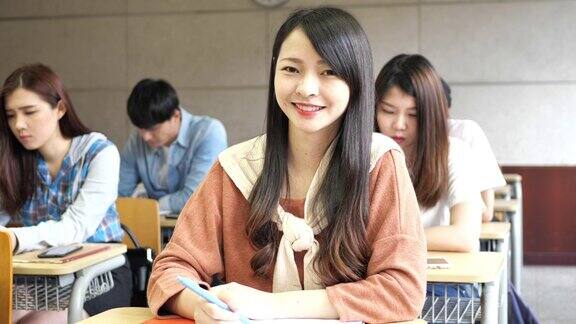 亚洲学生在教室里-大学学生在考试中看着摄像机