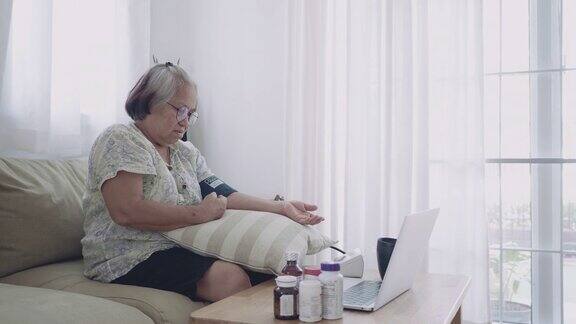 亚洲老年妇女在家测量血压