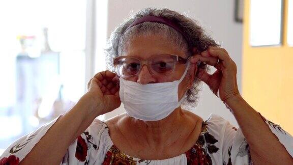 年长的女性在脸上戴着防护面具