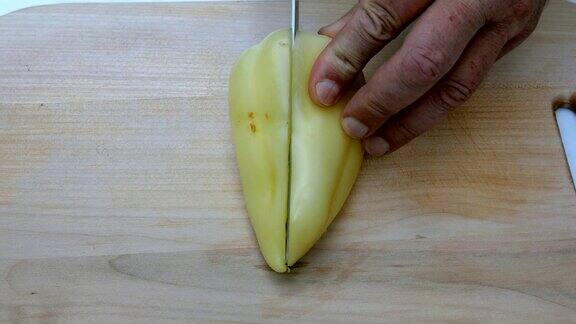 自制的烹饪人用手切一个甜椒用锋利的菜刀