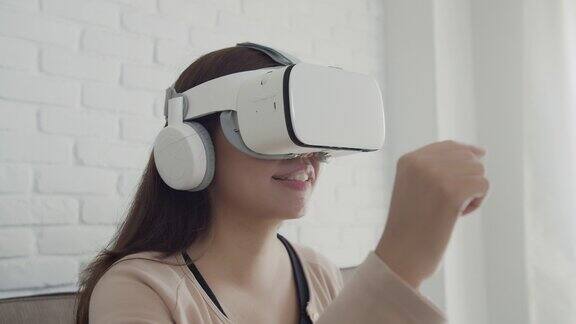 亚洲女性在家庭办公室使用VR眼镜