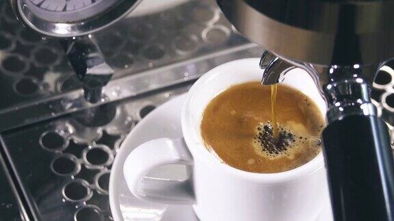 浓缩咖啡从经典的咖啡机倒入小的白色杯子