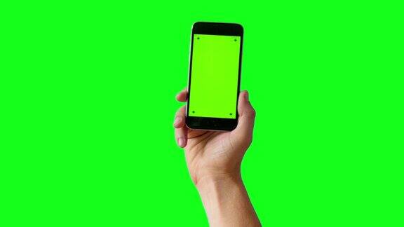 手持智能手机在绿色屏幕BG-4K