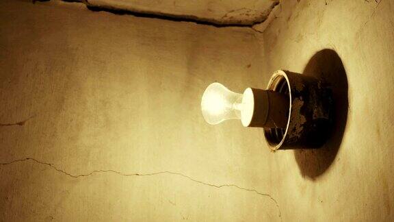 灯泡在老房子的混凝土墙上发光